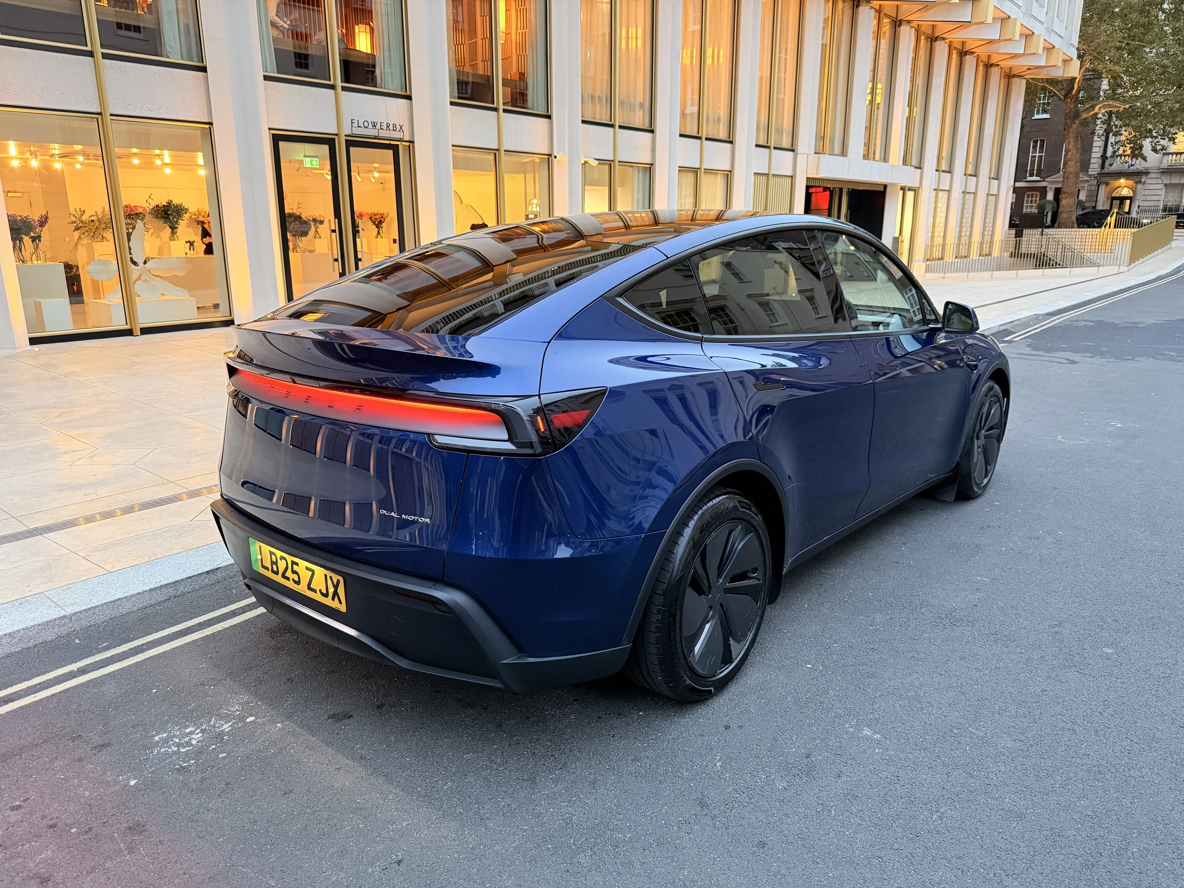 Deep Blue Metallic Tesla Model Y, rear three-quarter view