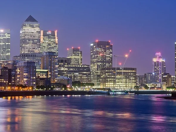 Canary Wharf skyline reflected in the river at twilight